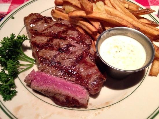 Manny's Steakhouse signature dishes "The Manny's" Bone-In Ribeye (often presented on a cart), Bludgeon of Beef (Tomahawk Steak), New York Strip, Filet Mignon, extensive selection of large-format steaks, classic sides like Manny's Hashbrowns.